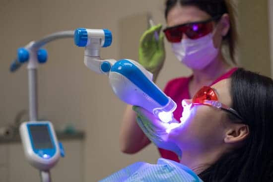 Female patient in dentist chair getting laser dental treatment done