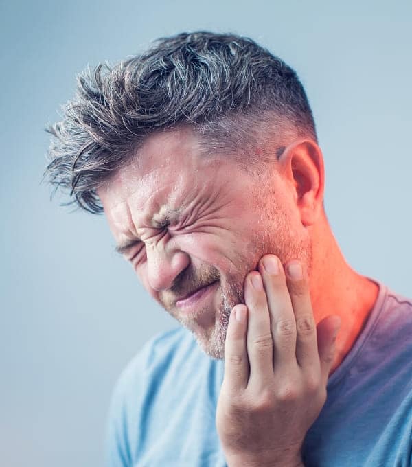 A man suffering from severe dental pain