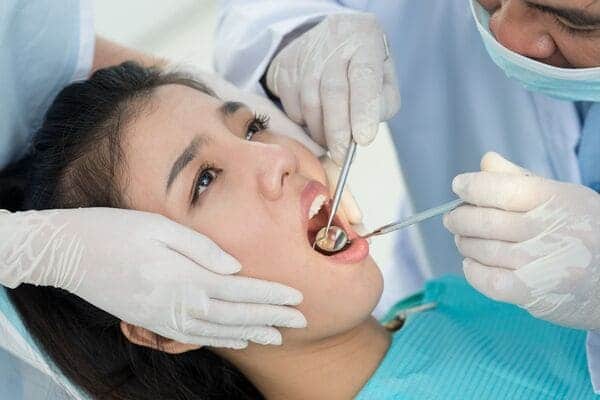  Doctor checked cracked tooth of girl