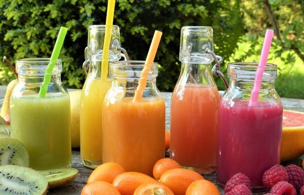 A variety of healthy fruit juices that a patient can drink after a dental implant procedure