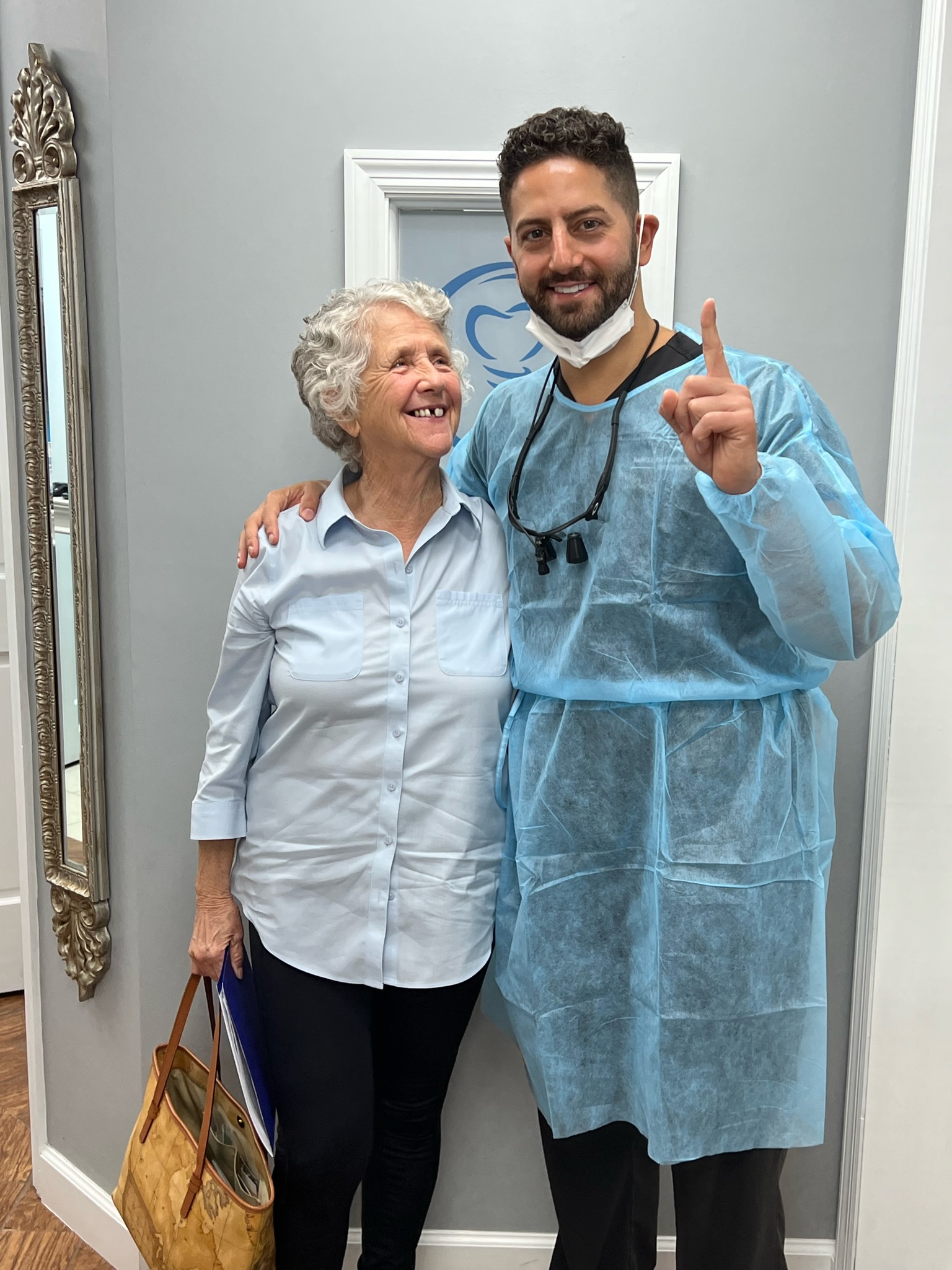 Dr. Raffoul with a happy implant patient